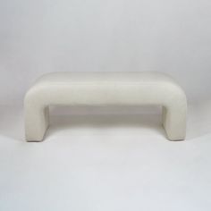 a white bench sitting on top of a white floor