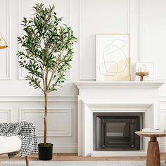 a living room with white walls and a tree in the corner next to a fireplace