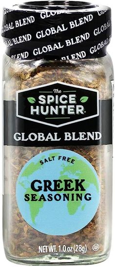 a jar filled with spices sitting on top of a white tablecloth next to a green globe