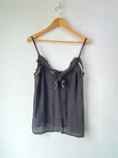 Comme des Garcons 2008 Black Sequin Cami! A sheer top that features black sequins along the collar and has spaghetti straps. 100% polyester. Dry Clean Only. Made in Japan. Marked a size medium. In excellent condition! Approx. Measurements: Underarm to Underarm: 19.5" Length: 25" Sheer Silk Party Tops, Black Sheer Tank Top For Evening, Chic Sheer Camisole For Evening, Black Silk Camisole Top, Black Sheer Spaghetti Strap Top, Sheer Cami Top For Evening, Embellished Spaghetti Strap Tank Top For Night Out, Sheer Silk Tops For Night Out, Black Sheer Silk Tops