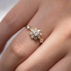 a woman's hand with a diamond ring on it