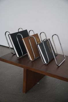 three pieces of luggage sitting on top of a wooden table