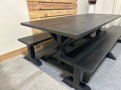 a wooden table with benches in front of it