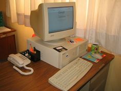 an old computer sitting on top of a desk