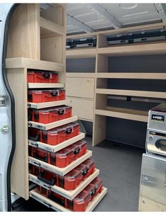 the inside of a van with many drawers and bins on each side of it