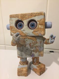 a small wooden toy with eyes and hands