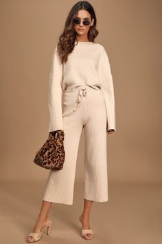 Get cozy on the couch in the Lulus Snuggly Style Cream Ribbed Knit Wide-Leg Pants! These cold-weather essential pants are shaped from ribbed knit and feature a high-waisted fit with decorative drawstring detail, and relaxed-fit, wide pant legs that end in ankle-grazing cropped hems. Pair with slippers and hot cocoa for maximum coziness! Chic Travel Outfit, Essential Pants, Knit Cropped Sweater, Cream Pants, Matching Sweaters, Matching Pants, Rounded Neckline, Fleece Joggers, Wide Pants