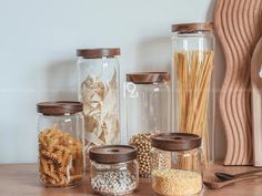 some glass jars and spoons on a table