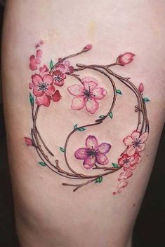 a woman's thigh with flowers on it and the letter g in the middle