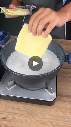 a person is using a sponge to mix together ingredients in a pan on the stove