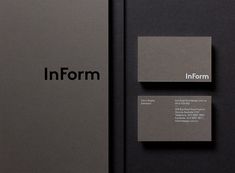 some business cards are placed next to each other on a black surface with the word inform printed on it