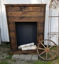 an old fashioned fire place with a wagon next to it