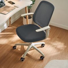 an office chair sitting in front of a desk with a laptop computer on top of it