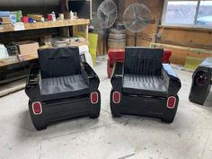 two chairs made out of old cars sit in a garage next to each other on the floor