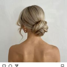 a woman with blonde hair in a low bun