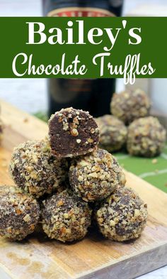 bailey's chocolate truffles stacked on a cutting board next to a bottle of booze