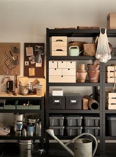 the shelves are filled with boxes, pots and other things to use in this work space