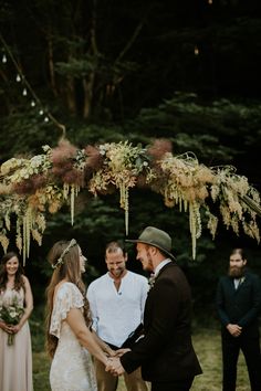 a man and woman holding hands during a wedding ceremony