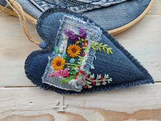 a pair of jeans with embroidered flowers on them