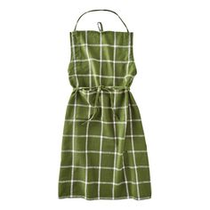 a green and white checkered dress hanging on a hanger in front of a white background