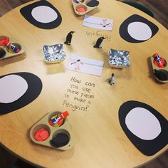 a wooden table topped with lots of different types of toys and writing on the surface