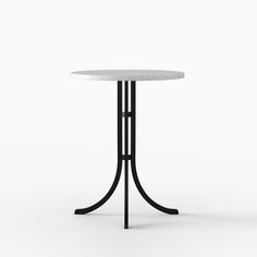 a white table with black metal legs and a round marble top on an isolated background