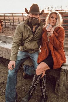 a woman sitting next to a man in cowboy boots