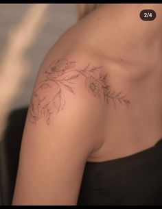 a woman with a tattoo on her shoulder