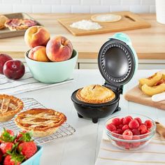 a table topped with pies, fruit and other food items on top of it