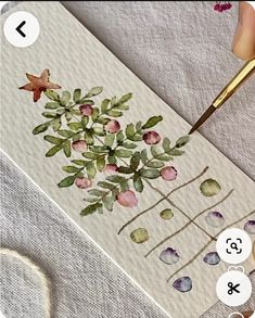 someone is painting flowers on a piece of paper