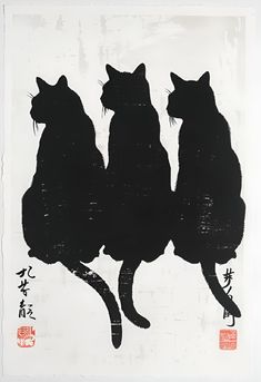 three black cats sitting on top of each other in front of a white background with chinese writing