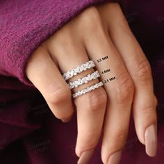 a woman's hand with three rings on her finger and the measurements for each ring