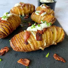 baked potatoes with bacon and cream cheese on a slate board