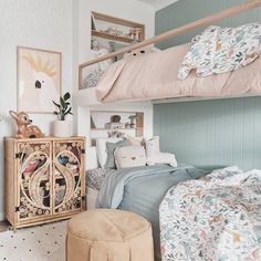 a bedroom with two bunk beds next to each other and a small stool in front of the bed