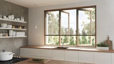 an empty kitchen with open windows and white dishes on the counter top, along with shelves filled with pots and pans