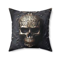 a decorative pillow with a gold skull on the front and black background, which has swirls in it