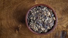 a bowl filled with granola sitting on top of a wooden table