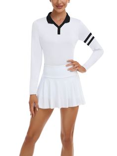 a woman in a white tennis outfit posing for the camera with her hands on her hips