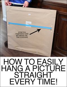 a person holding a brown bag with the words how to easily hang a picture straight every time