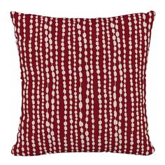 a red pillow with white dots on it