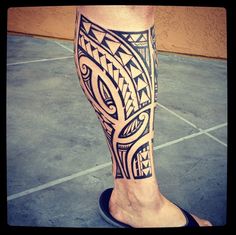 a man's leg with an intricate tattoo design on the lower part of his leg