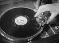 a person is pressing the knob on a record player