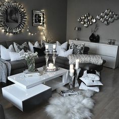 a living room filled with lots of furniture and candles on top of it's coffee table