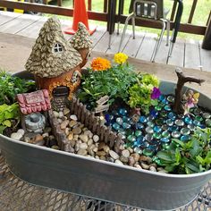 a container filled with lots of plants and rocks