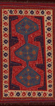 a red and blue rug with designs on it