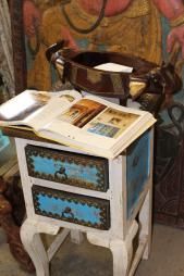 an old fashioned table with a magazine on top