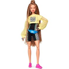 a barbie doll wearing a yellow shirt and black shorts with her hands on her hips