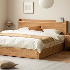 a large bed sitting next to a white rug on top of a hard wood floor