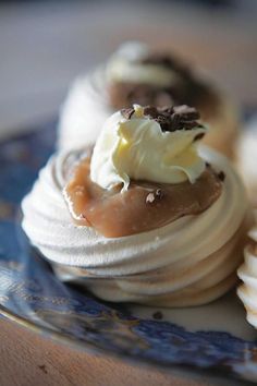 a plate with some desserts on it sitting on top of a blue and white plate