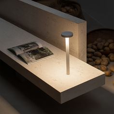 a table with a lamp on it next to some doughnuts and other items